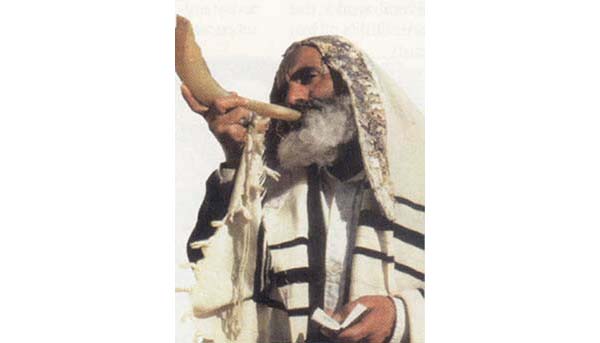 A rabbi blowing on a shofar